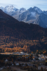 autumn in the Swiss Alps with its colors, mountains, glaciers and typical villages, near the village of Maloja, Engadine, Switzerland