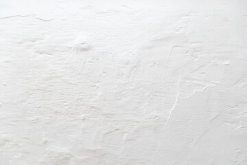 The tecture of the gray plastered and chalk-covered wall is close-up. Background in the form of a fragment of the wall.