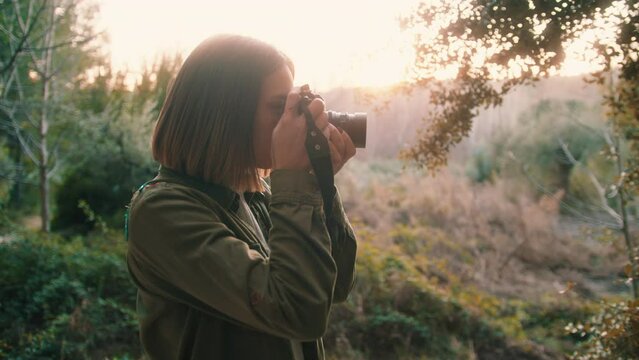 Young Female Photographer In Autumn Forest - medium shot