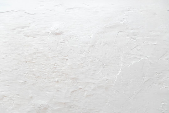 The tecture of the gray plastered and chalk-covered wall is close-up. Background in the form of a fragment of the wall.