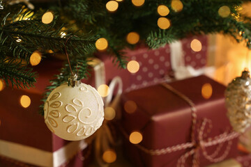 Closeup view of Christmas tree with beautiful decor and gift boxes