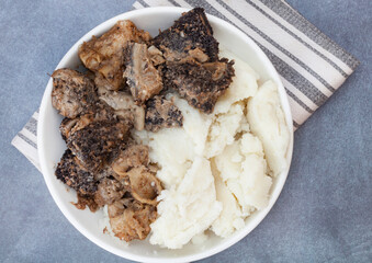 Mogodu, a Traditional South African stew made of chopped innards of a cow or tripe served with pap or maize meal.