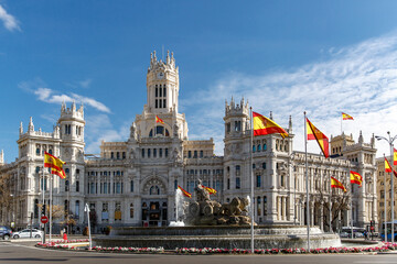 A lot of Spanish flags in Plaza Cibeles in Madrid, Spain. - obrazy, fototapety, plakaty