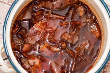 the traditional painted of red Easter eggs, in water with onion peels in Romania, Bistrita