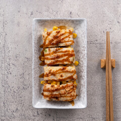 Delicious Taiwanese omelette, egg pancake roll with ham and corn kernels.
