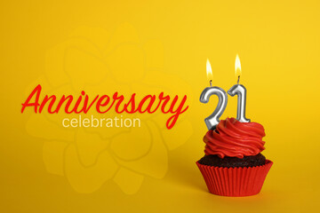 Delicious cupcake with number shaped candles on yellow background. Coming of age party - 21th birthday. Anniversary celebration