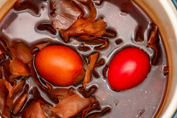 the traditional painted of red Easter eggs, in water with onion peels in Romania, Bistrita