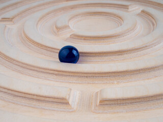 Fototapeta na wymiar Wooden labyrinth balance board on white background. Close-up. Montessori toy