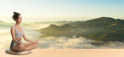 Young African American woman practicing yoga on wooden surface against beautiful mountain landscape, space for text. Banner design
