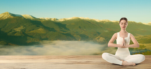 Naklejka na ściany i meble Young woman practicing yoga on wooden surface against beautiful mountain landscape, space for text. Banner design