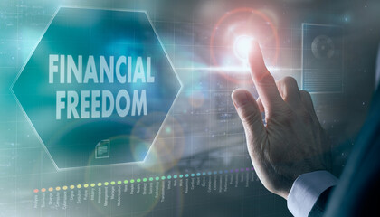 A businessman controlling a futuristic display with a Financial Freedom business concept on it.