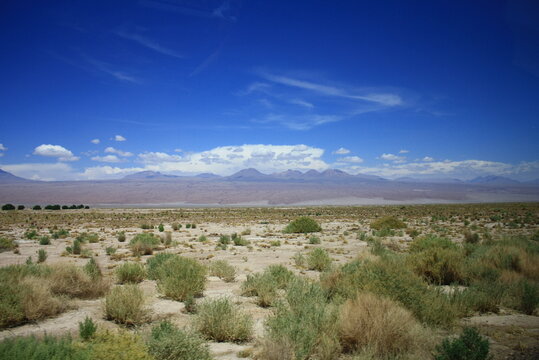 The landscape of the Atacama Desert in Chile, with clouds, volcano, lsand and salt.