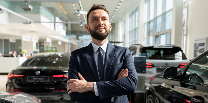 a man in a stylish business suit chooses a new car