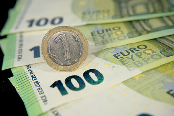 one hundred euro banknotes of the European Union, one Bulgarian lev macro photo