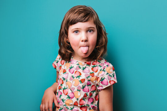 Girl showing tongue in studio