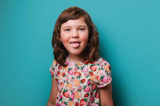 Girl showing tongue in studio