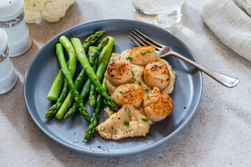 Pan-fried scallops with cauliflower and bean puree and asparagus