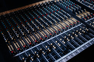 Sound recording studio mixing desk. Music mixer control panel. Closeup. 