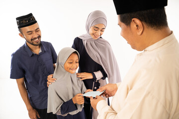 muslim parent giving a suprise gift to their child during idul fitri celebration