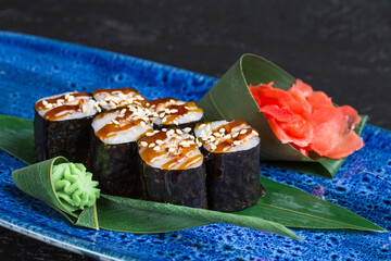 Fresh sushi dish on a blue plate.