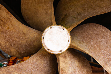 Ship's bronze propeller at the stern of the ship, close-up.