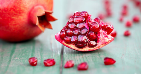 Natural antioxidant banner, pomegranate ripe sweet organic healthy red fruits and seeds
