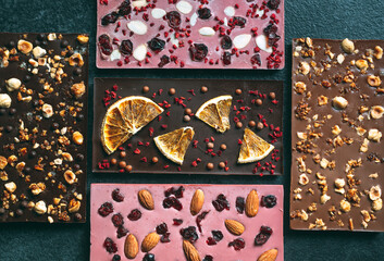 Handmade chocolate bars with a variety of dried fruit and nut toppings.