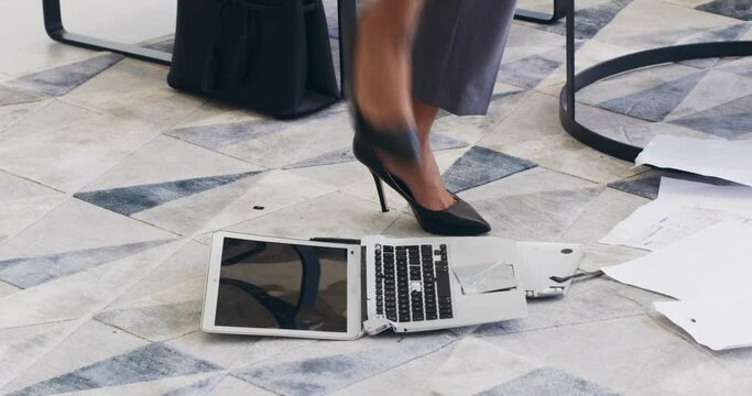 Forgetting to save your work and then your laptop crashes. 4k video footage of a businesswoman breaking a laptop in a a modern office.