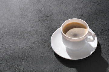  coffee in a white cup on a dark background. coffee break concept
