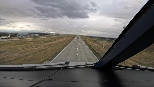 Cockpit view of a Landing in a modern wide-body passenger, cargo aircraft ,  runway 22 at Dresden Airport, Germany, Captains View from short before touch down until roll out on a cloudy rainy day