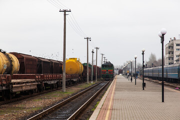 Fototapeta na wymiar Freight and passenger trains at Kherson railway station in Ukraine.