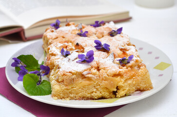 apple pie sprinkled with powdered sugar and flowers, original serving of the dish