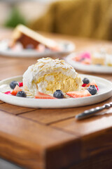 meringue roll with strawberries, blueberries, raspberries and cranberries. Dessert decorated with fresh berries