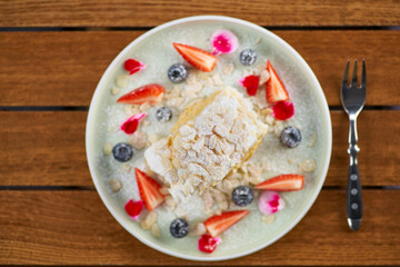 meringue roll with strawberries, blueberries, raspberries and cranberries. Dessert decorated with fresh berries