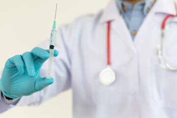 Close up of a doctor holding a syringe. Vaccination concept medical and disease prevention.