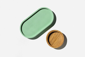 Podium for cosmetic product presentation. Abstract minimal geometrical form on white background. Oval stone form, shadow. Scene, Showcase, display. Minimal design. Trendy sunlight. Flat lay, Top View