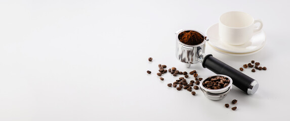 Obraz na płótnie Canvas carob coffee machine tools, coffee beans, empty cups on white background, banner