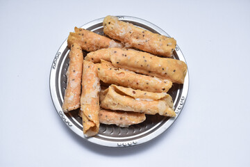 South Indian traditional crunchy snack of madakku (sweet kuzhalappam) made with rice flour and a little sesame seeds.