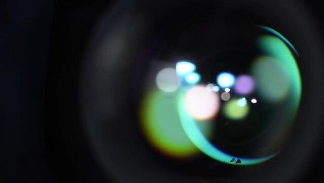 Round Colorful Flares On Optical Glass of Camera Lens. Macro Shooting of Opening Aperture Blades