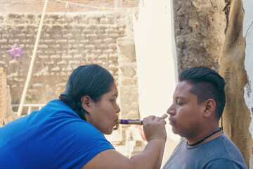 woman applying monkfish ancestral medicine in Mexico - obrazy, fototapety, plakaty