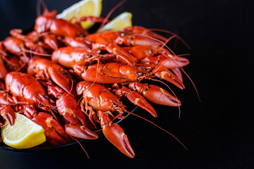 red crawfish with lemon on dark wood table
