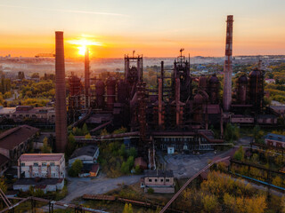 Fototapeta premium Blast furnace equipment of the metallurgical plant at the sunset, aerial view