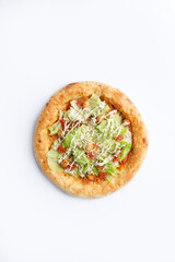 Homemade pizza with greens and sun-dried tomatoes. On a white background.