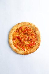 Homemade pizza with cheese and sun-dried tomatoes. On a white background.