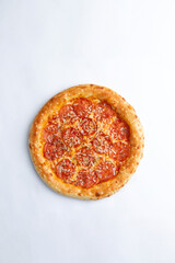 Homemade pizza with cheese and sausages. On a white background.