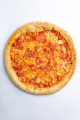 Big pizza with cheese and ham. On a white background.