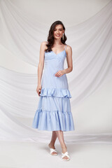 Naklejka premium Beautiful sexy brunette woman wear summer collection dress style cruise collection fashion model silk textile elegant clothes makeup cosmetic glamour studio.