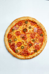 Big pizza with sausages and ham. On a white background.