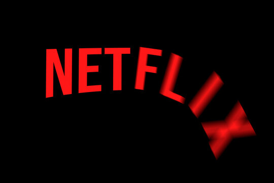 Celadna, Czechia - 04.21.2022: Approximation of Netflix logo with letters falling down as from the cliff. Concept for shares plummeting, valuation decrease, company crisis. Stock price plunge.