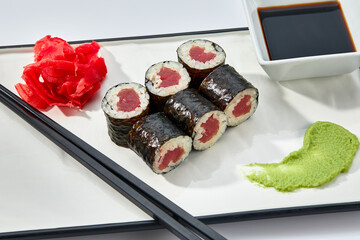 Sushi rolls and chopsticks on white background, space for text. Japanese food